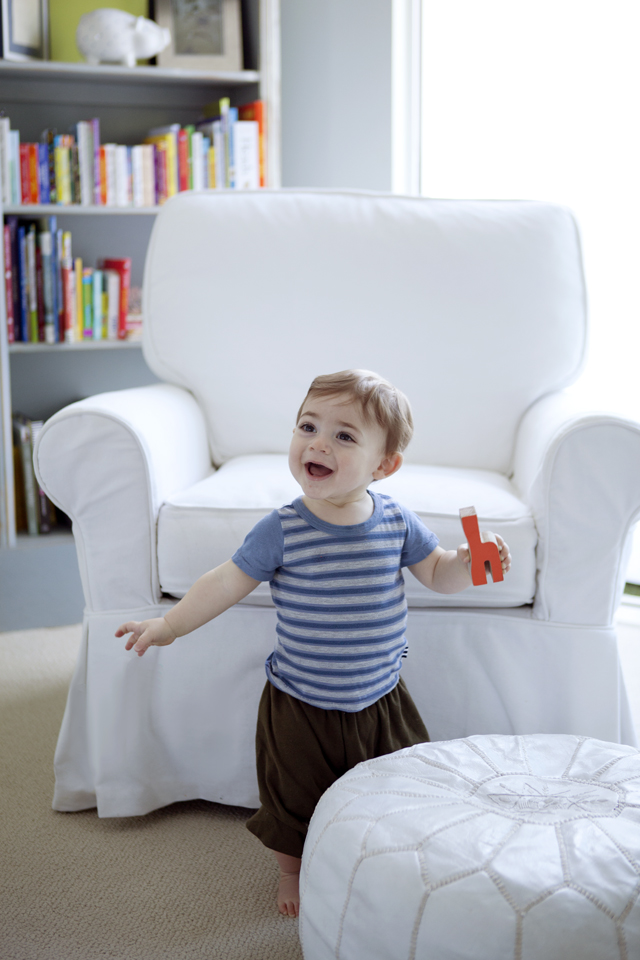 Casual Nursery with White Upholstered Glider and Pouf
