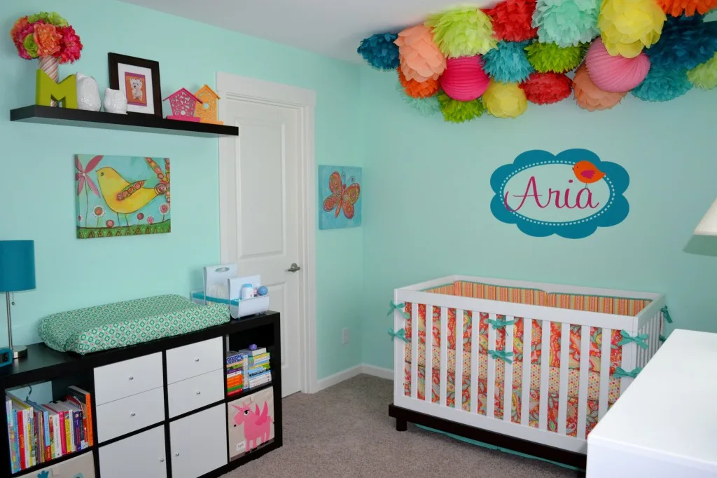 colorful aqua girl's nursery with tissue poms