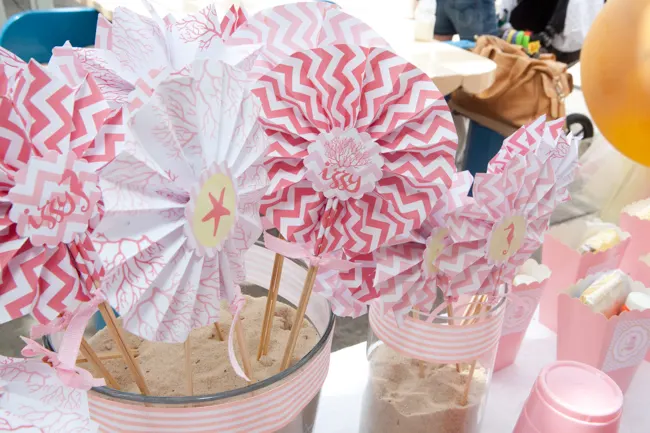 pink diy party fans at beach themed birthday party