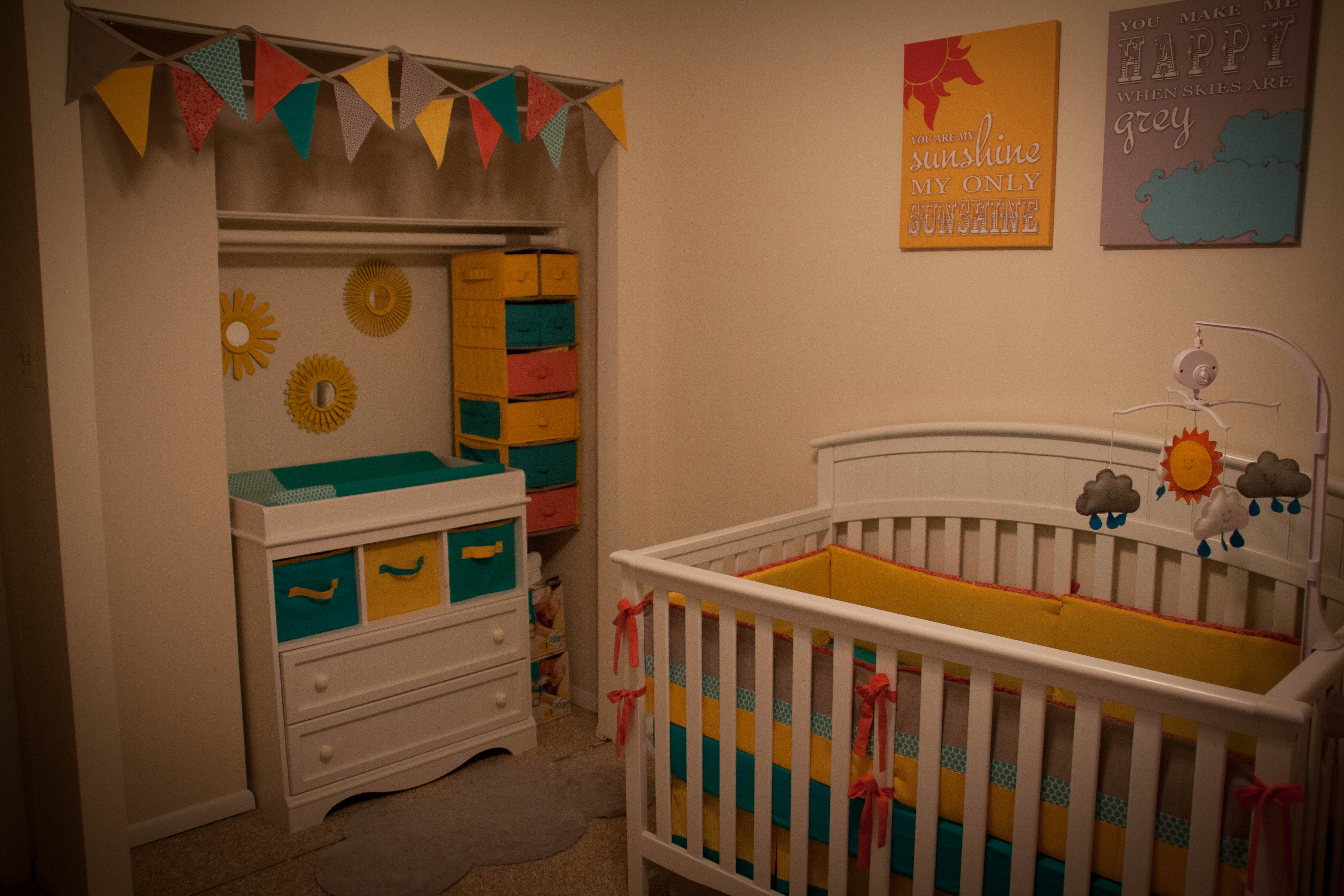 White Changing Table with Teal and Yellow Storage Baskets
