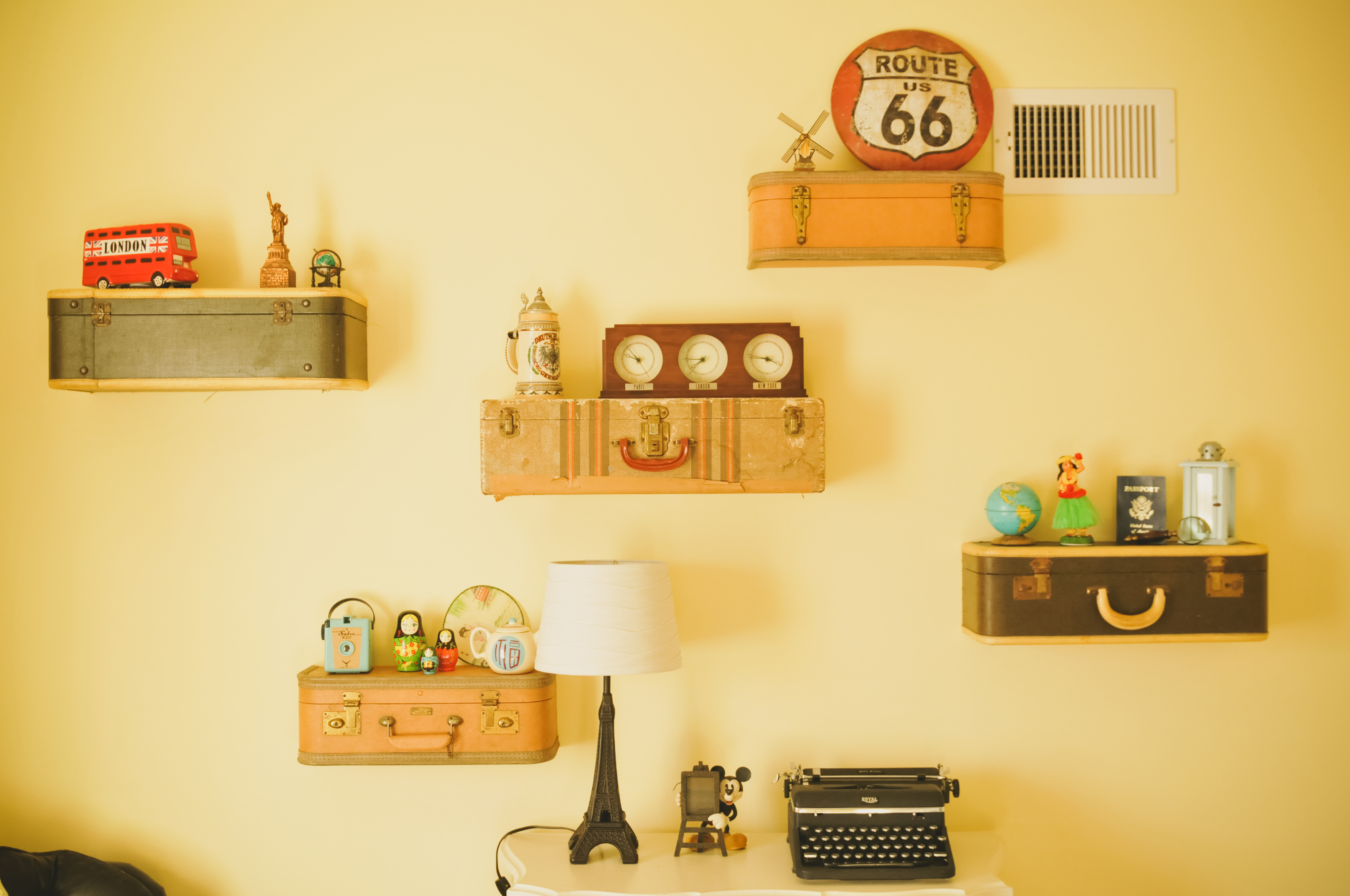 Vintage Suitcase Shelves with Travel Pieces from Around the World