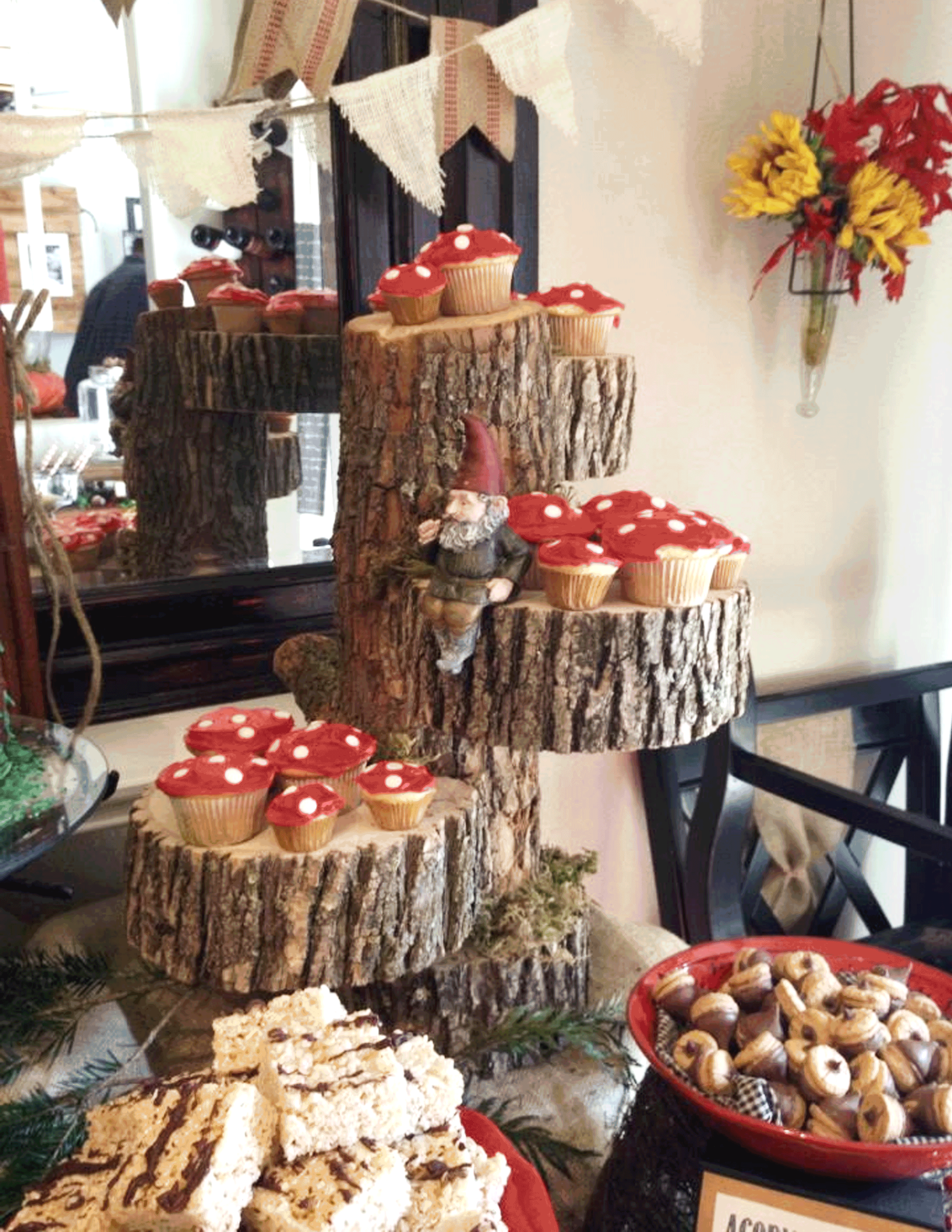 Toad Stool Cupcakes Displayed on Tree Trunks