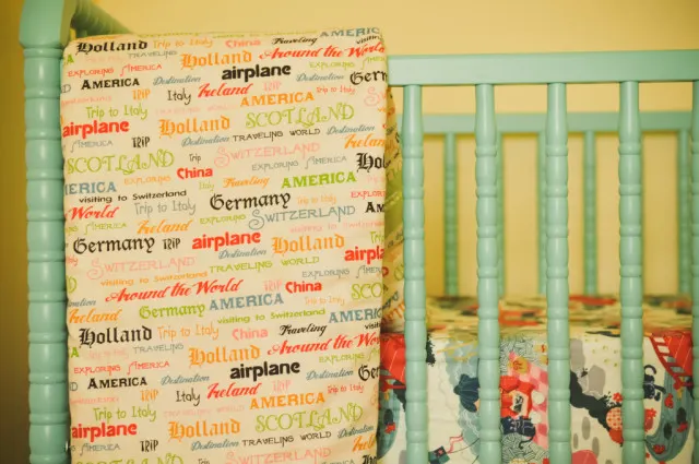 Blue Jenny Lind Crib with Travel-Themed Sheets - Project Nursery