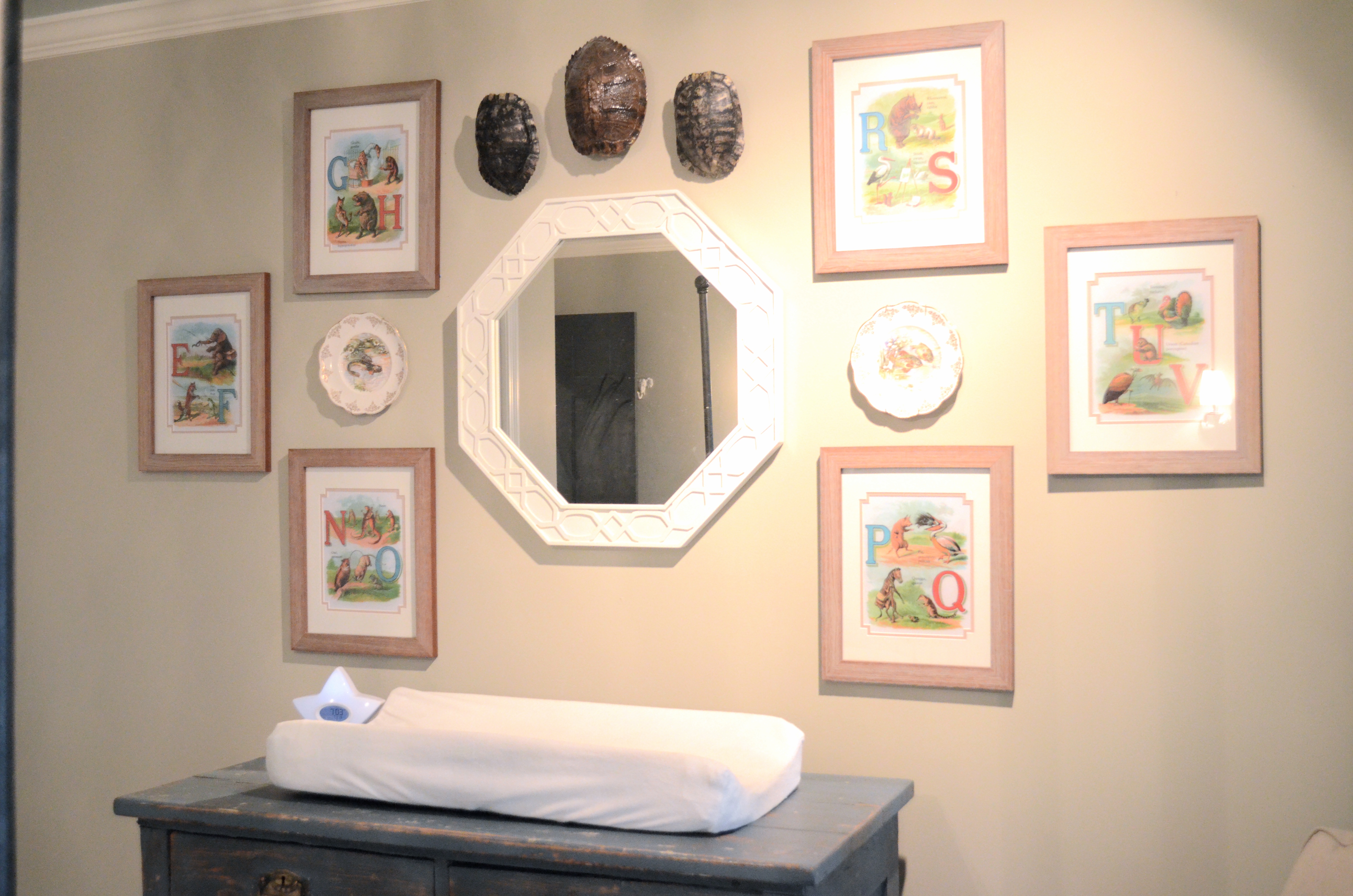 Alphabet Prints Featured Around Mirror in this Natural Nursery