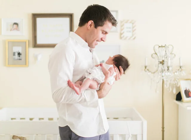 Newborn Baby and Father in Nursery