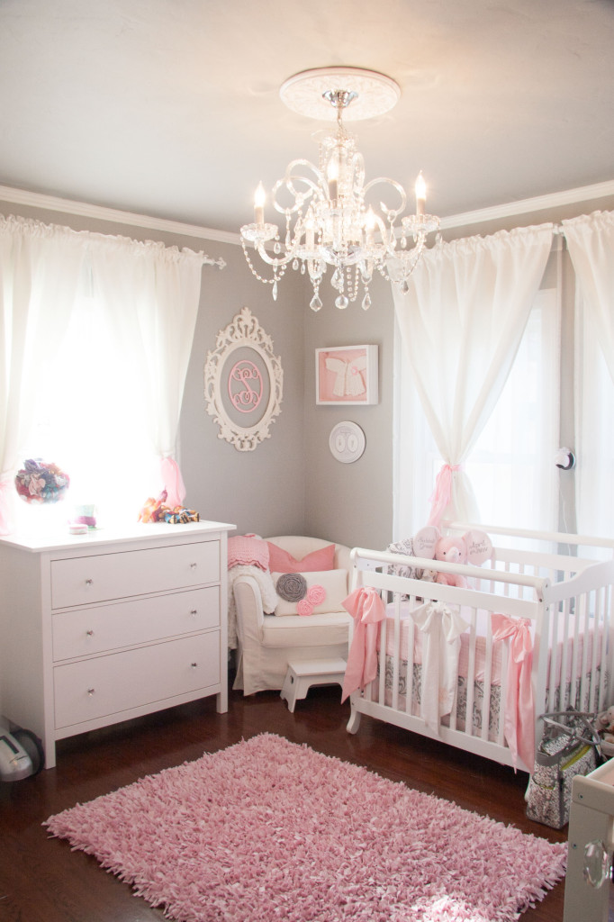 pink and gray nursery with dark furniture