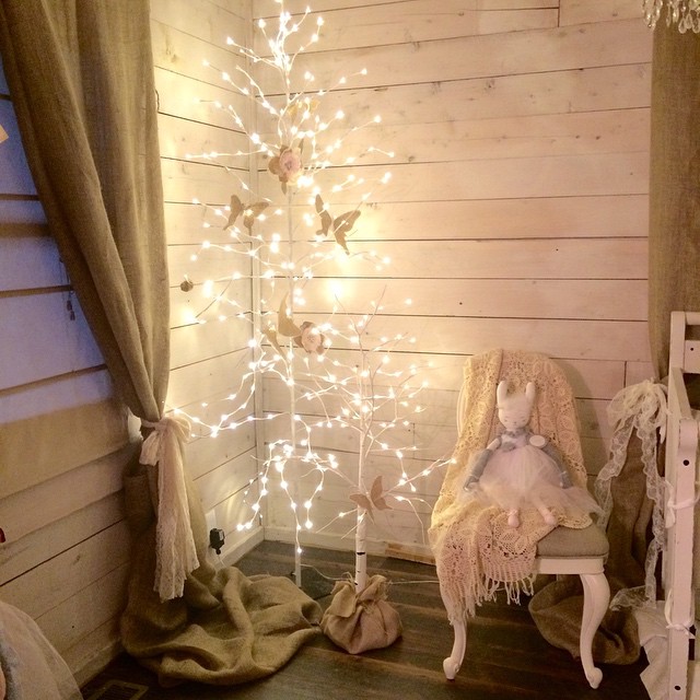 Lighted Trees and Twinkle Lights in this Cozy Cabin Nursery