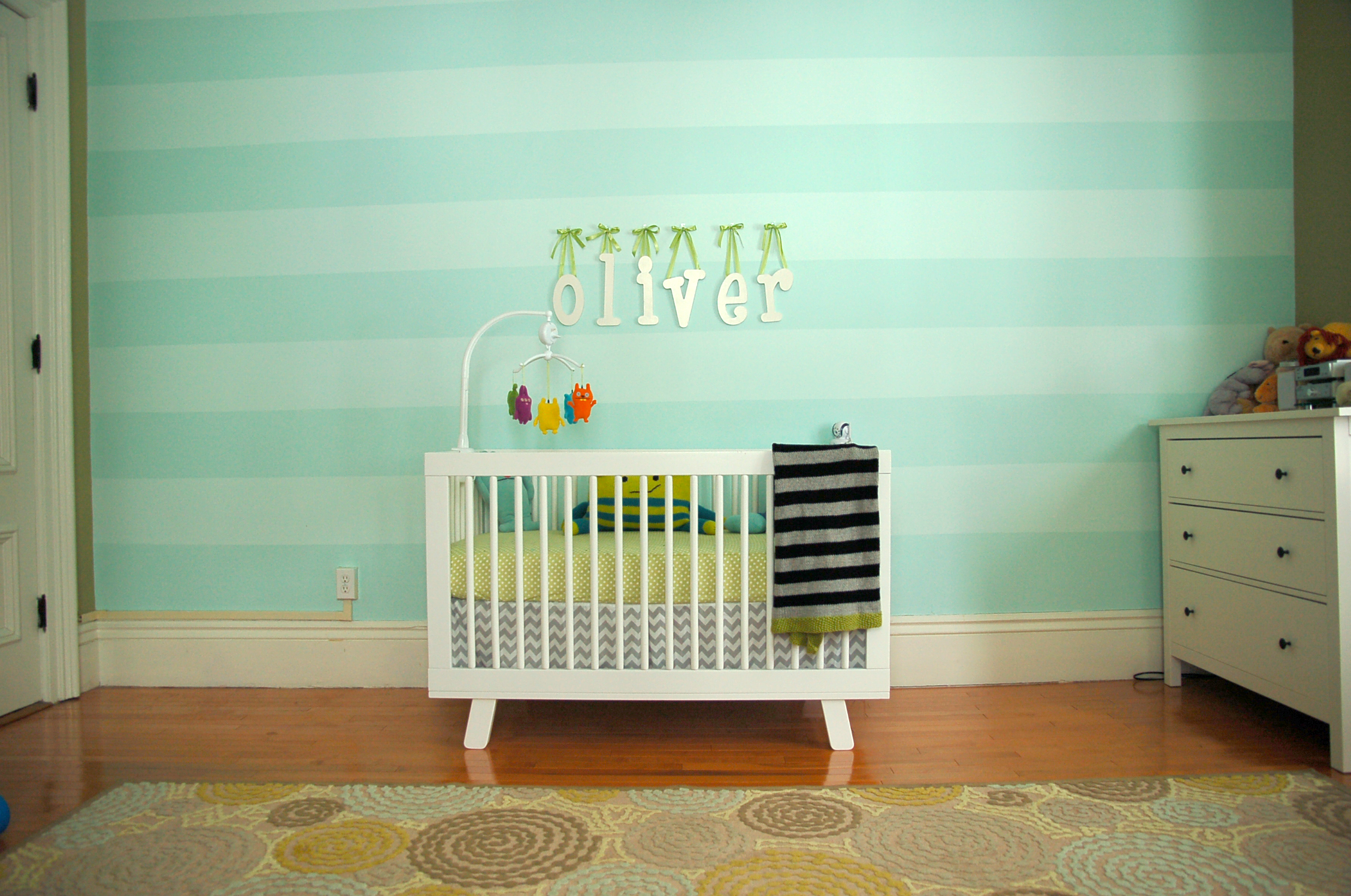 Aqua Stripe Accent Wall in this Cheerful Monster Nursery