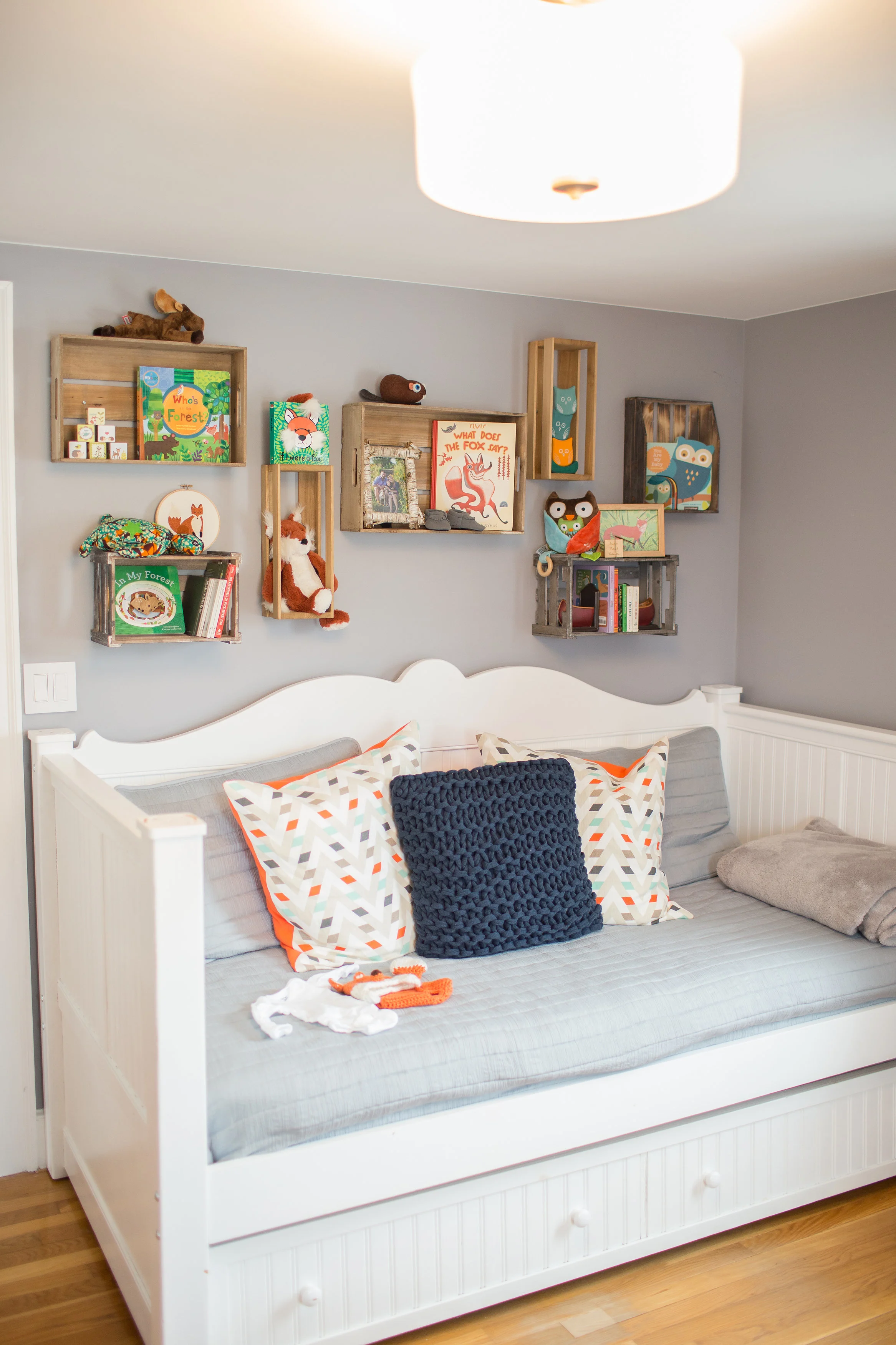 Wall of Crates over Daybed in this Woodland Nursery