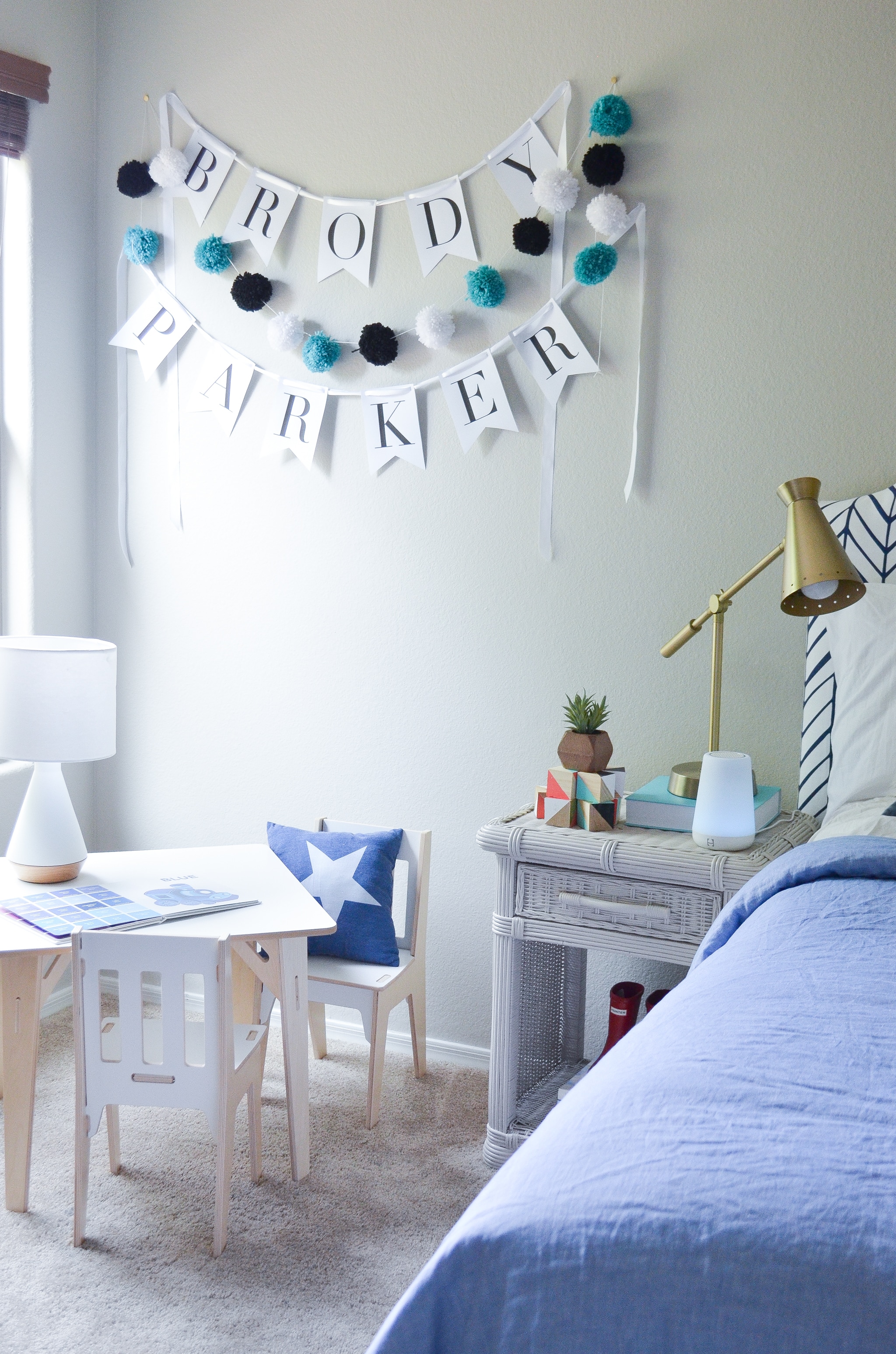 Name Banner and Pom-Pom Garland in Toddler Boy's Room - Project Nursery