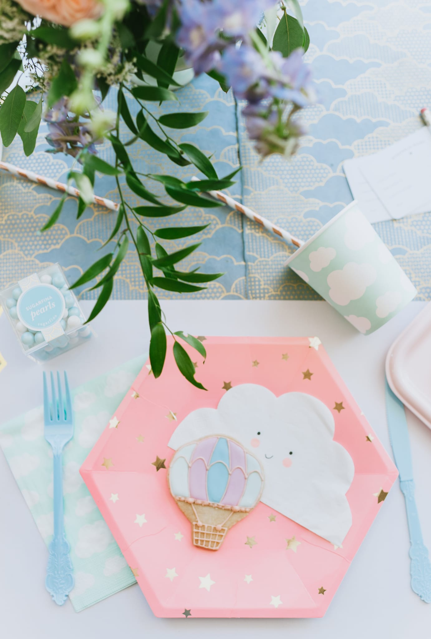 Hot air balloon baby shower place setting with pink and gold star plate cloud cups and napkins and hot air balloon cookies - Project Nursery