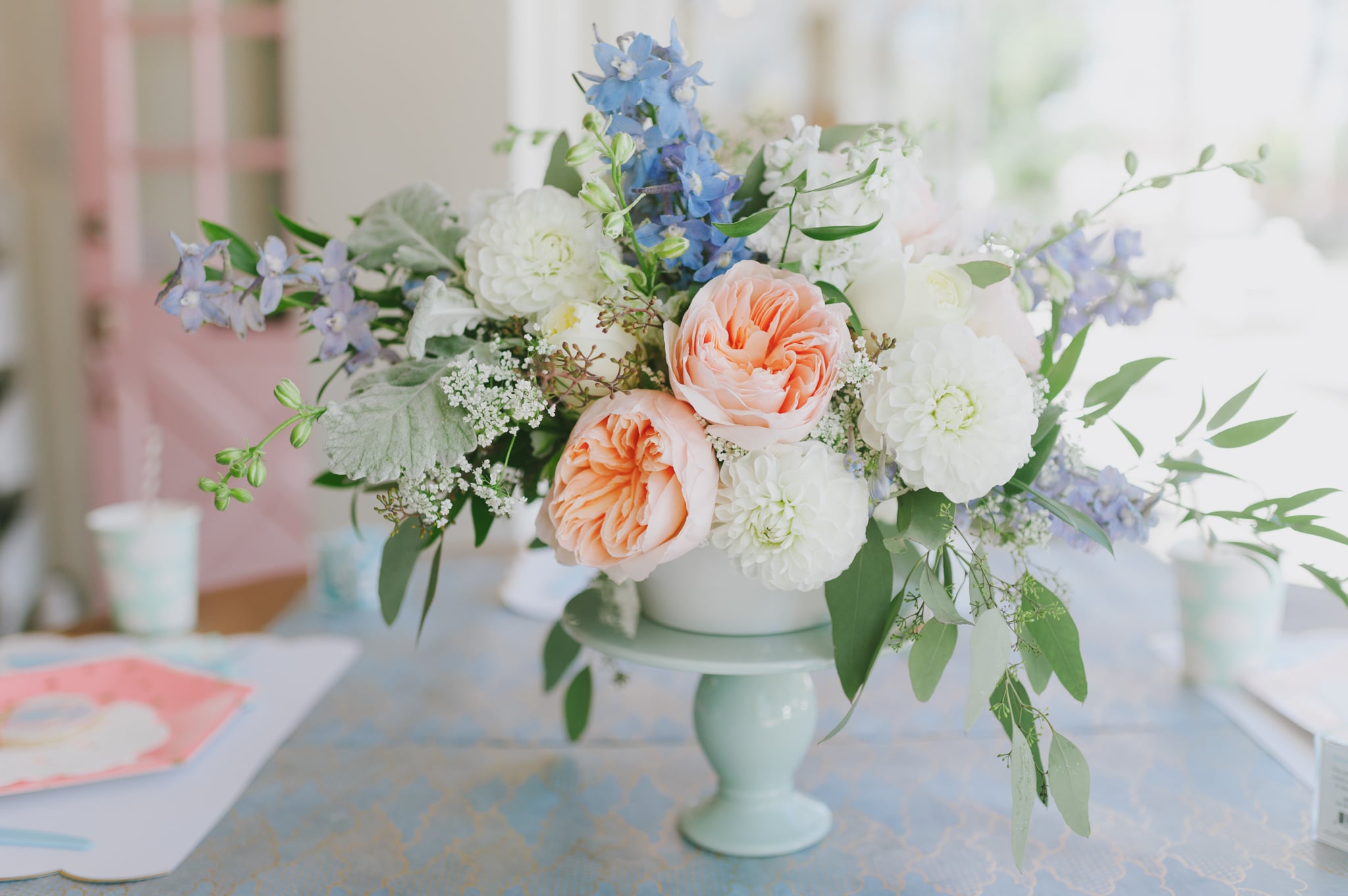 Pastel floral arrangement on mint cake stand - Project Nursery