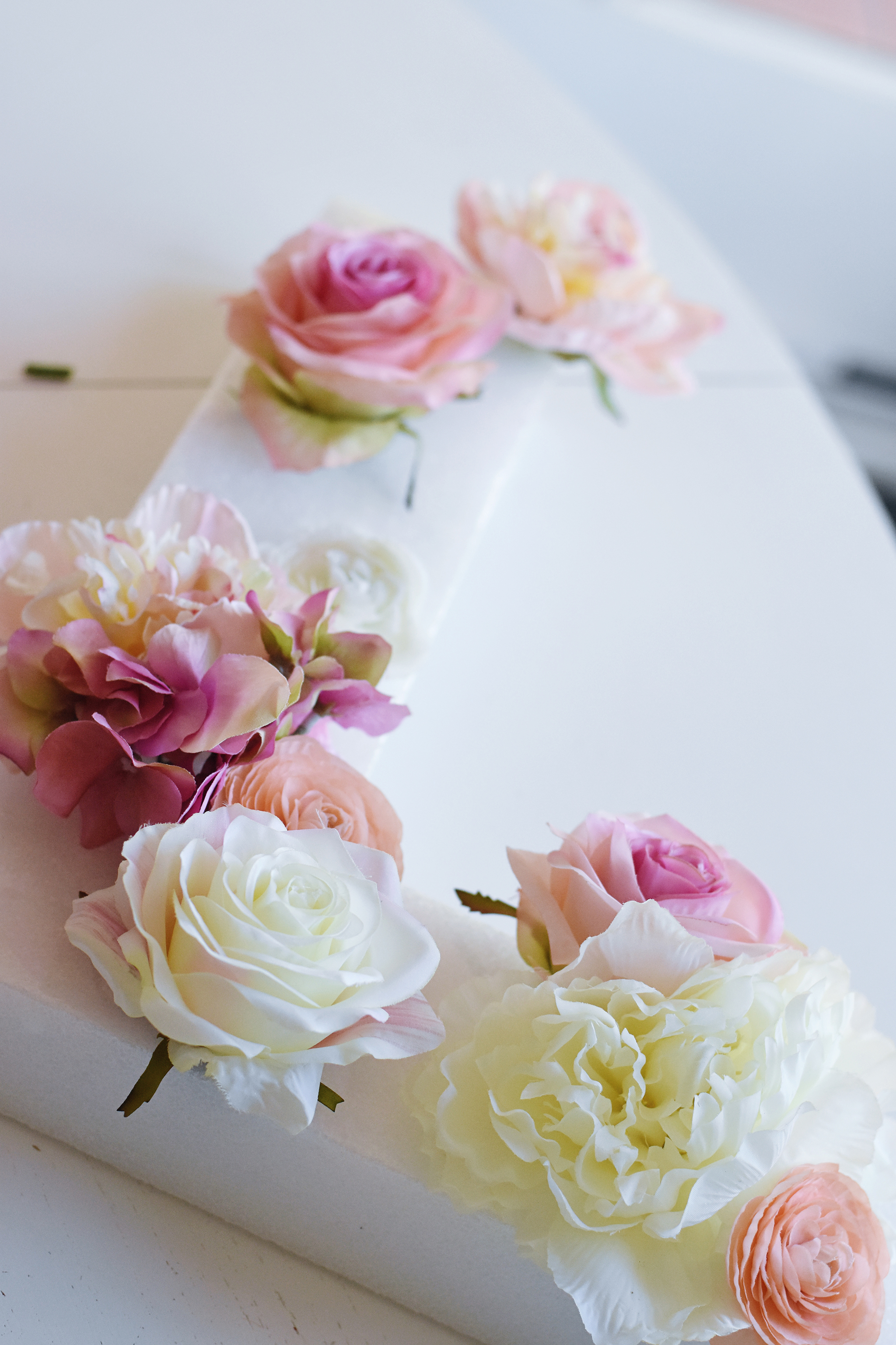Start by placing your larger flowers first, then fill in with smaller ones.