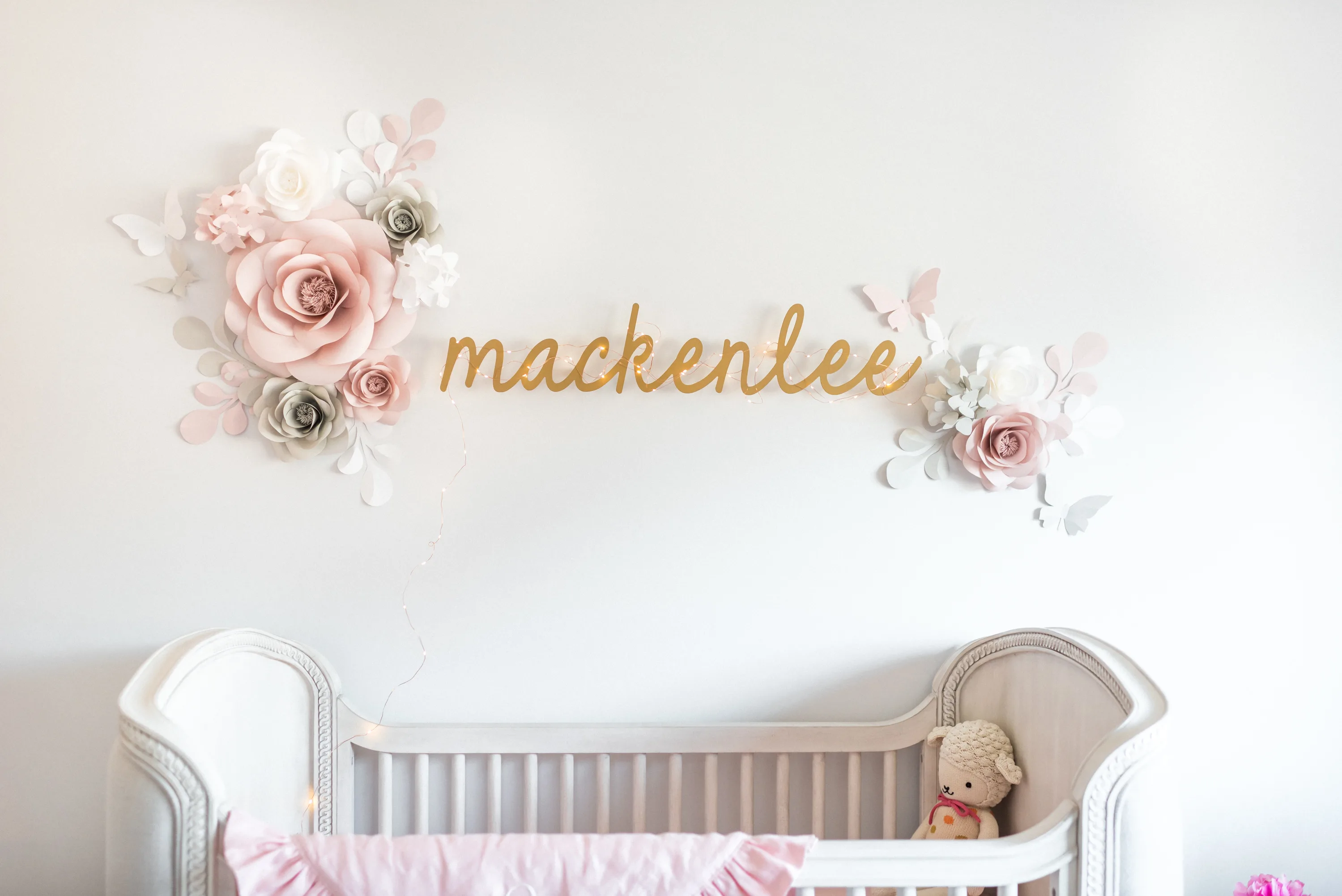 Gold Name and Paper Flowers Above Crib