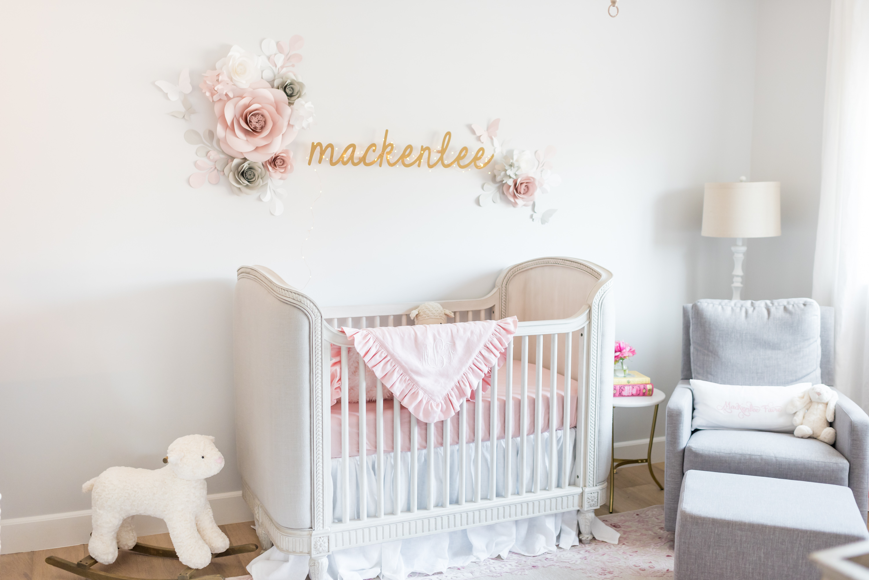 Pink and Gray Nursery with Paper Flowers Above Crib
