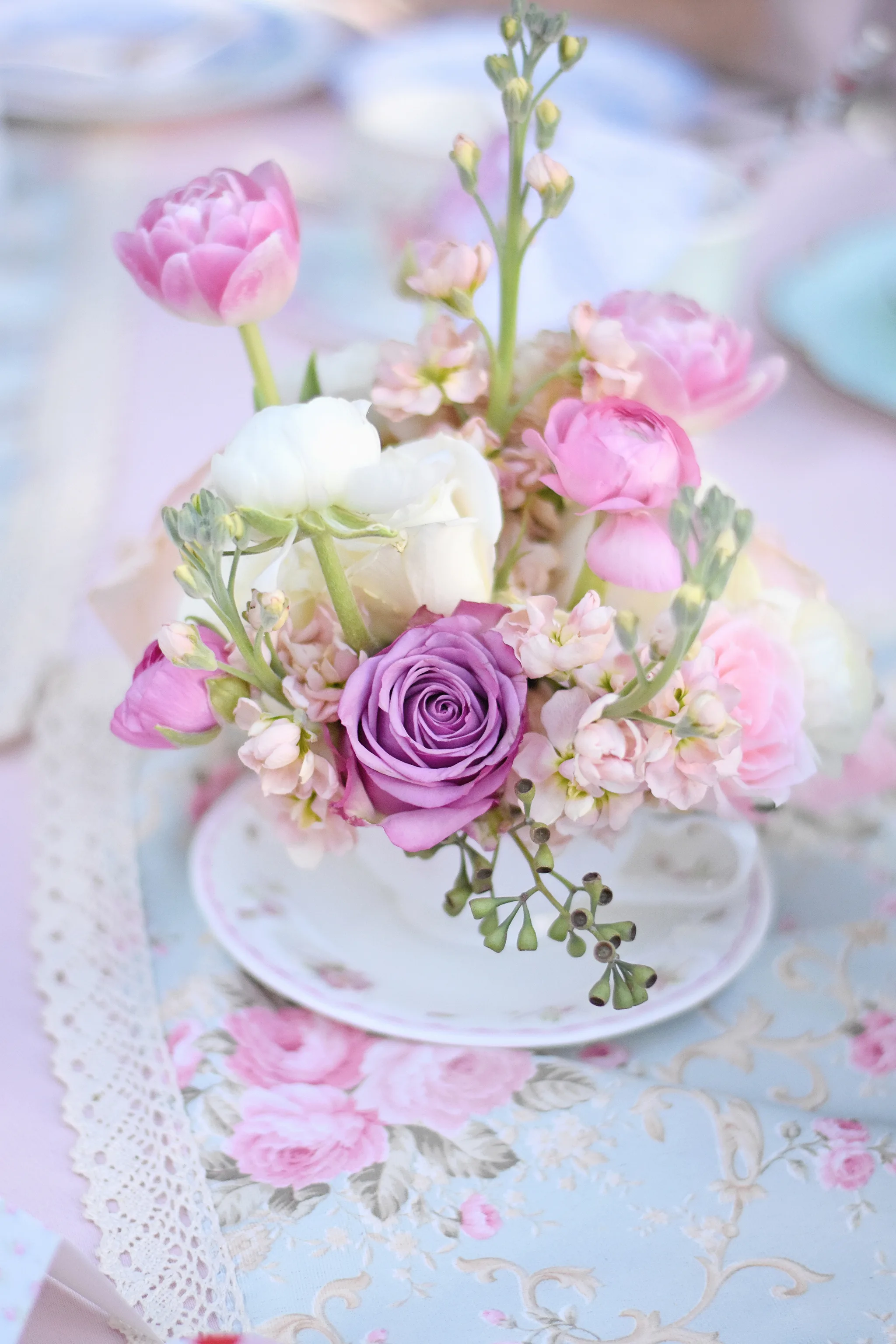 Use teacups and saucers as vases for small centerpieces