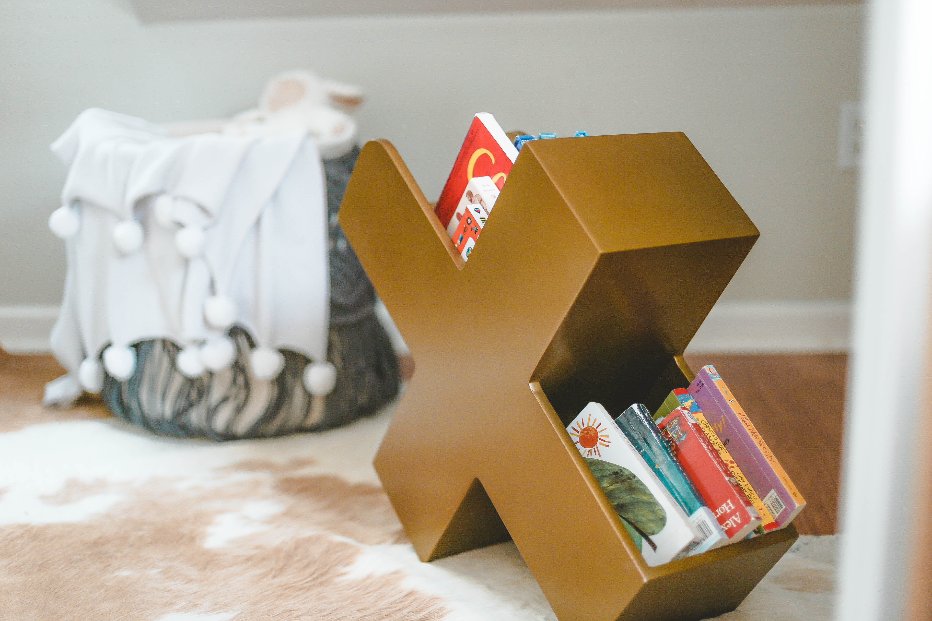 Eclectic Boy's Nursery with X Book Caddy