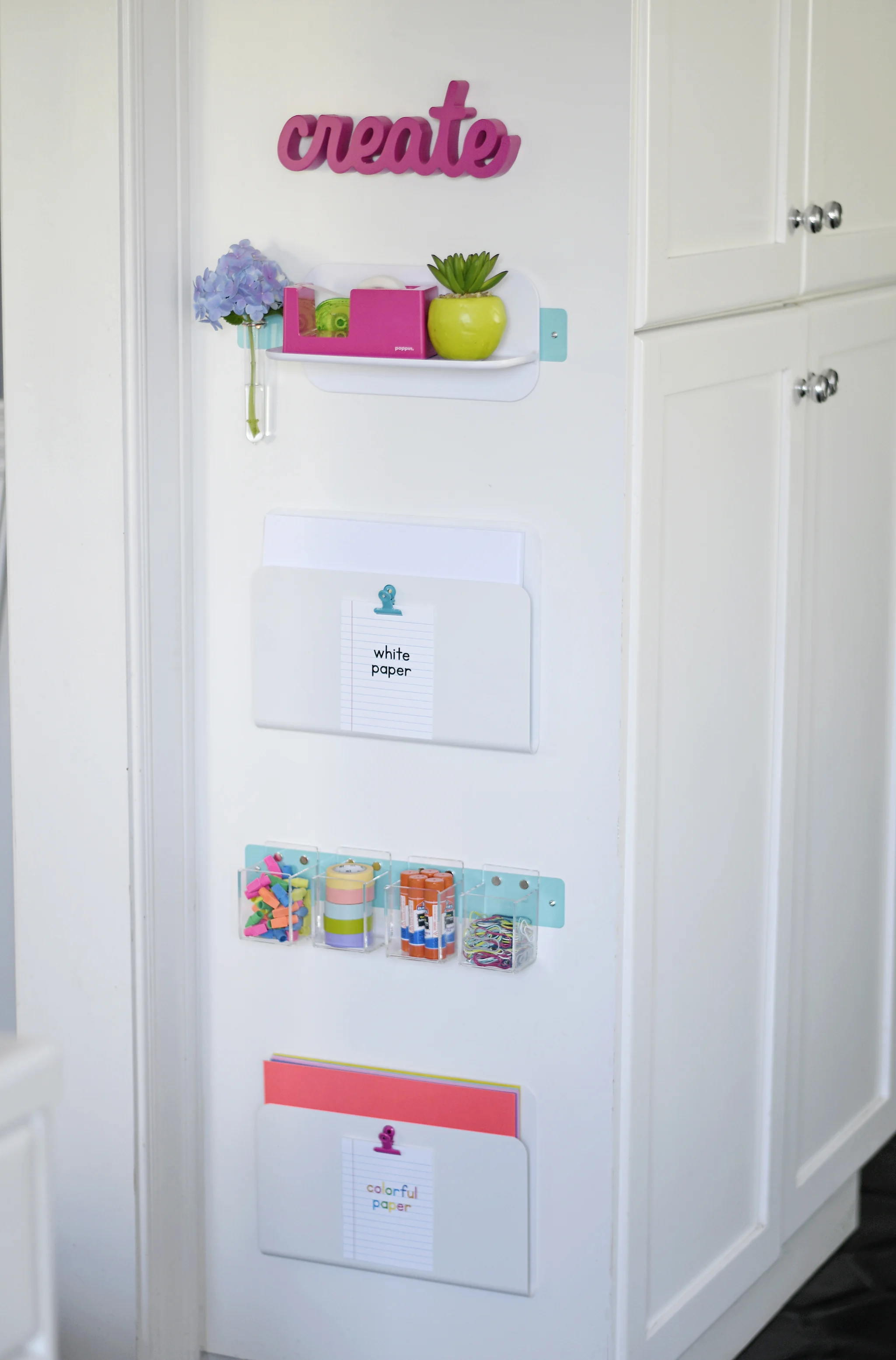 Magnetic strips and wall pockets hold papers and small items!a