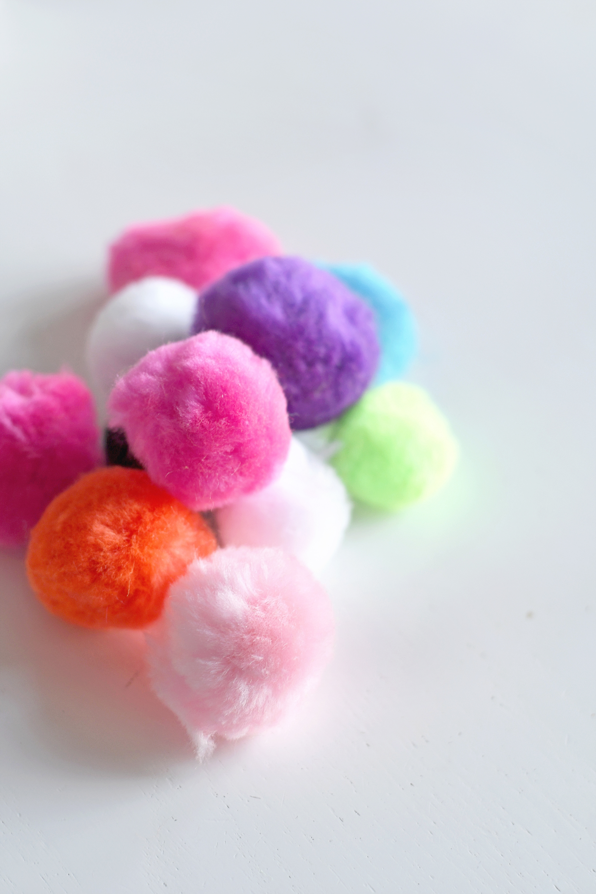 Buy pom-poms at a local craft store