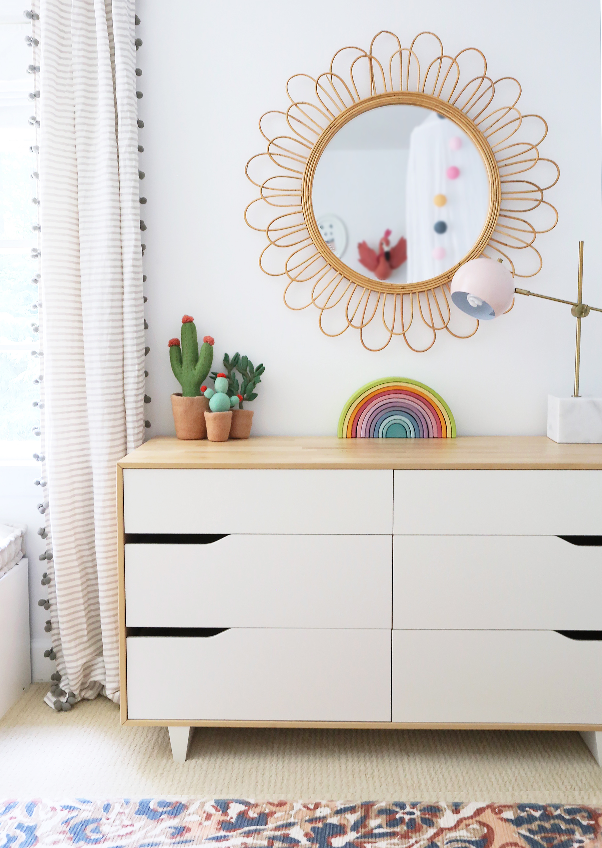 Rattan Mirror Over Dresser in Whimsical Girl's Room