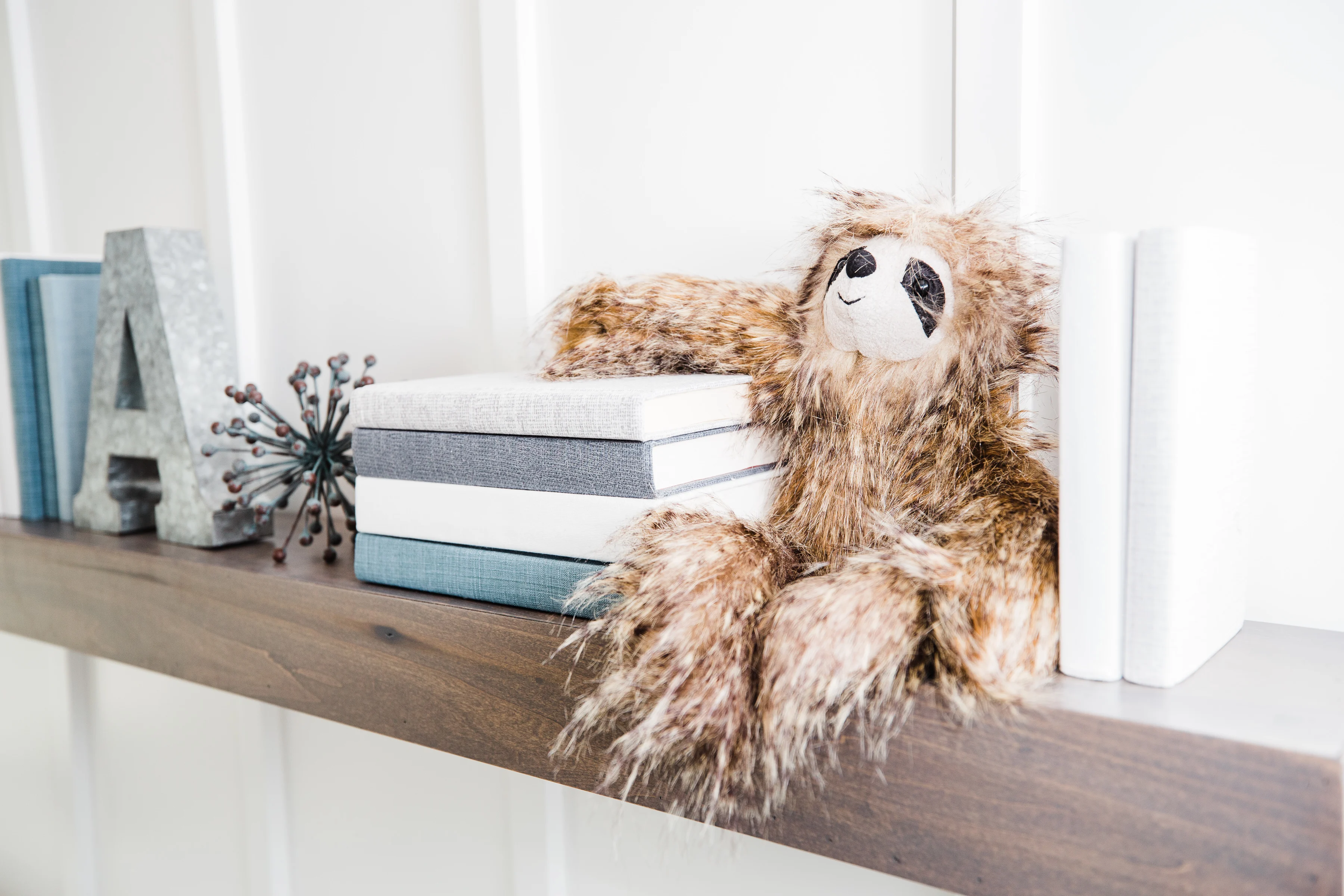 Sloth Stuffed Animal on Nursery Shelf