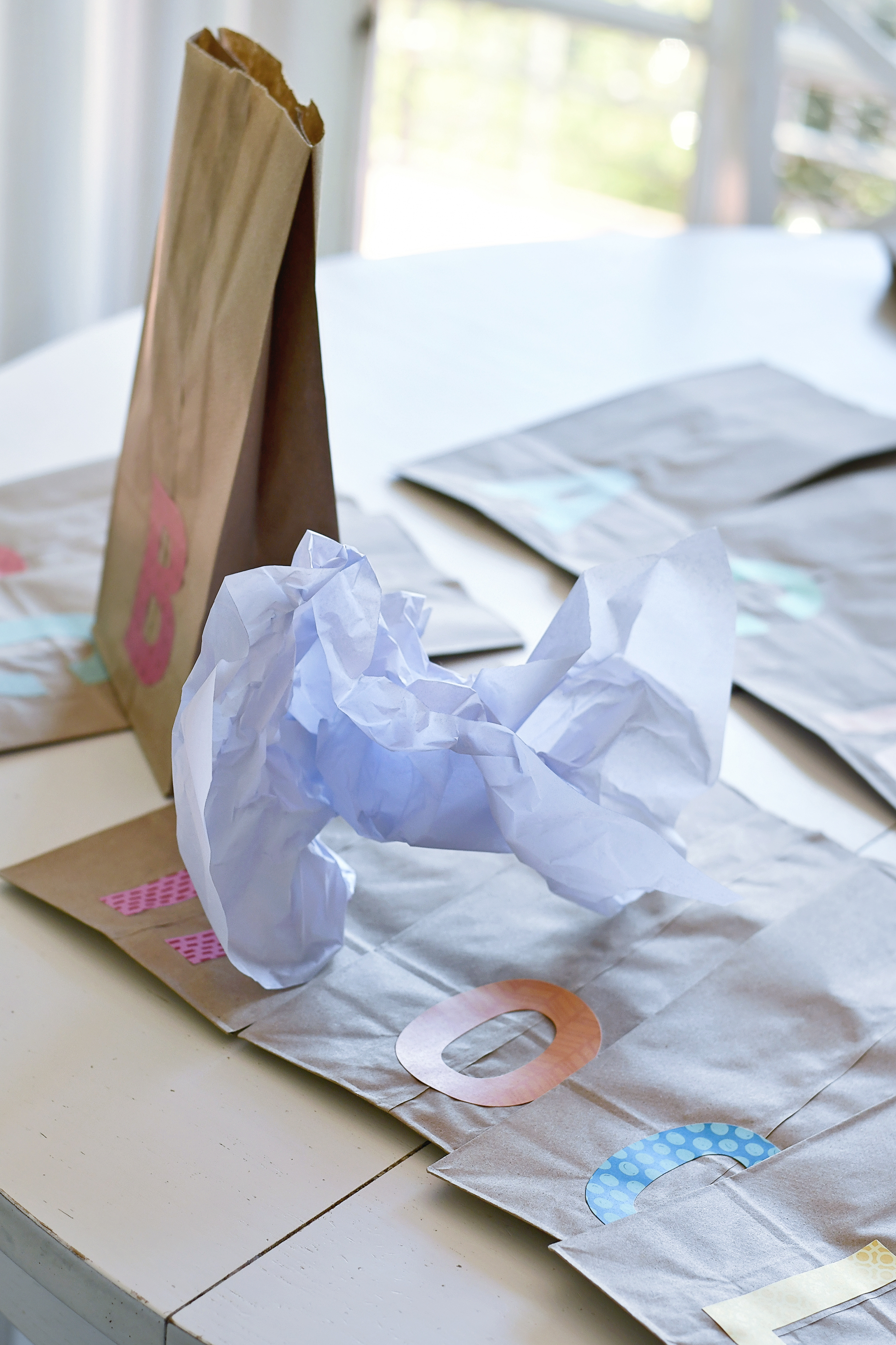 Fill each sack with 1/2 sheet of wadded up tissue paper