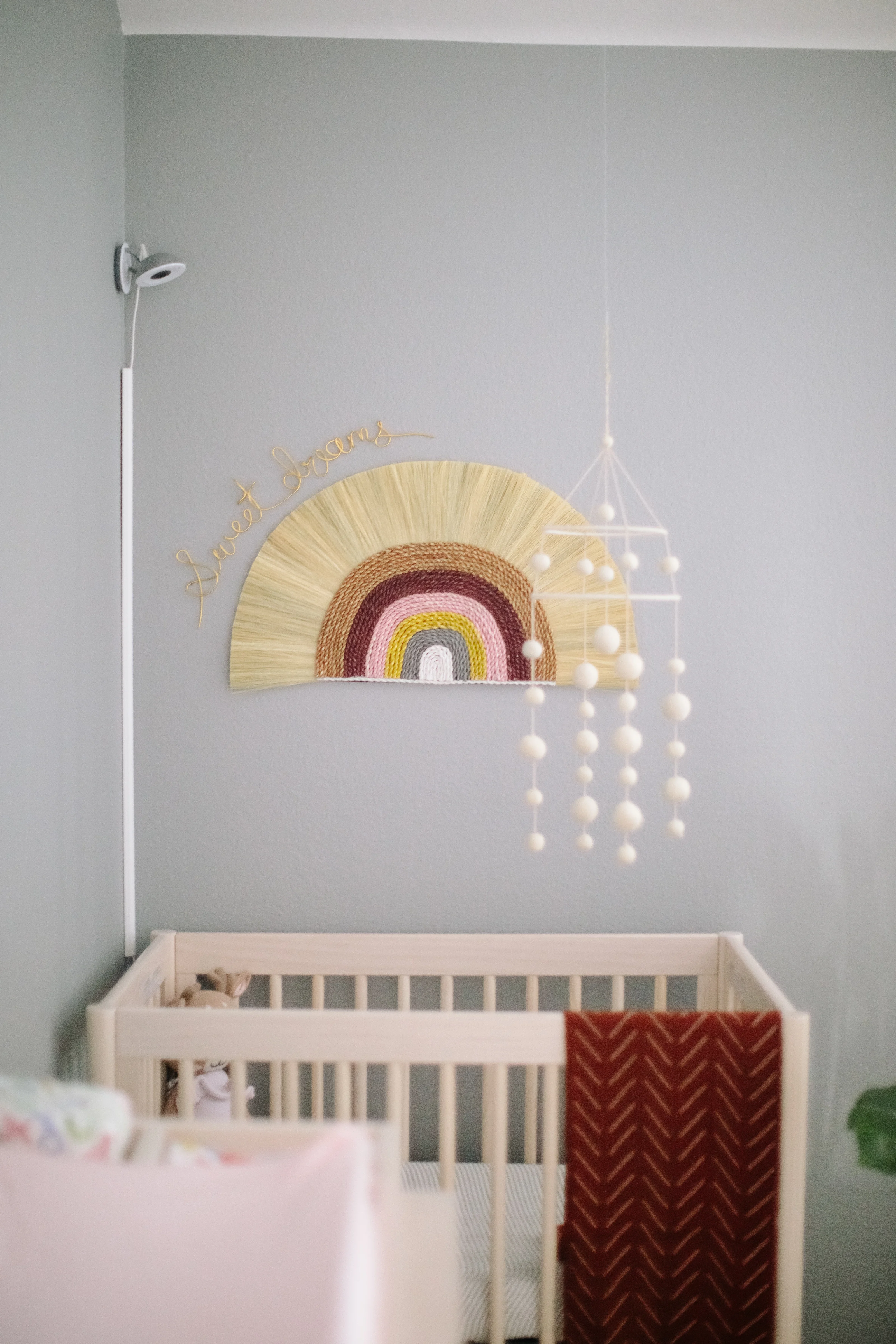 Boho Rainbow Wall Hanging with Felt Ball Mobile in Nursery Nook