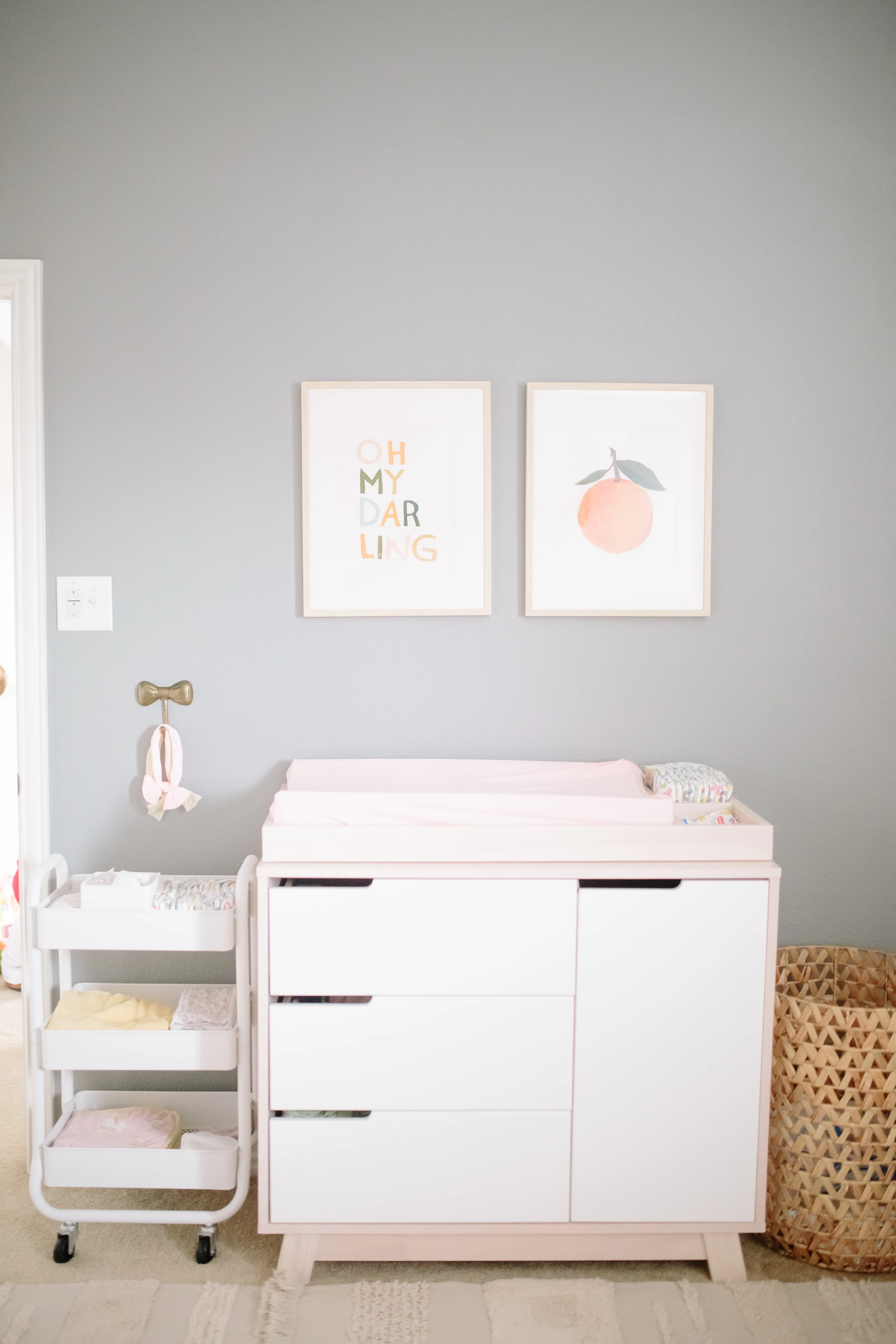 Citrus Art Print Above Nursery Changing Table with Rolling Cart for Diaper Organization