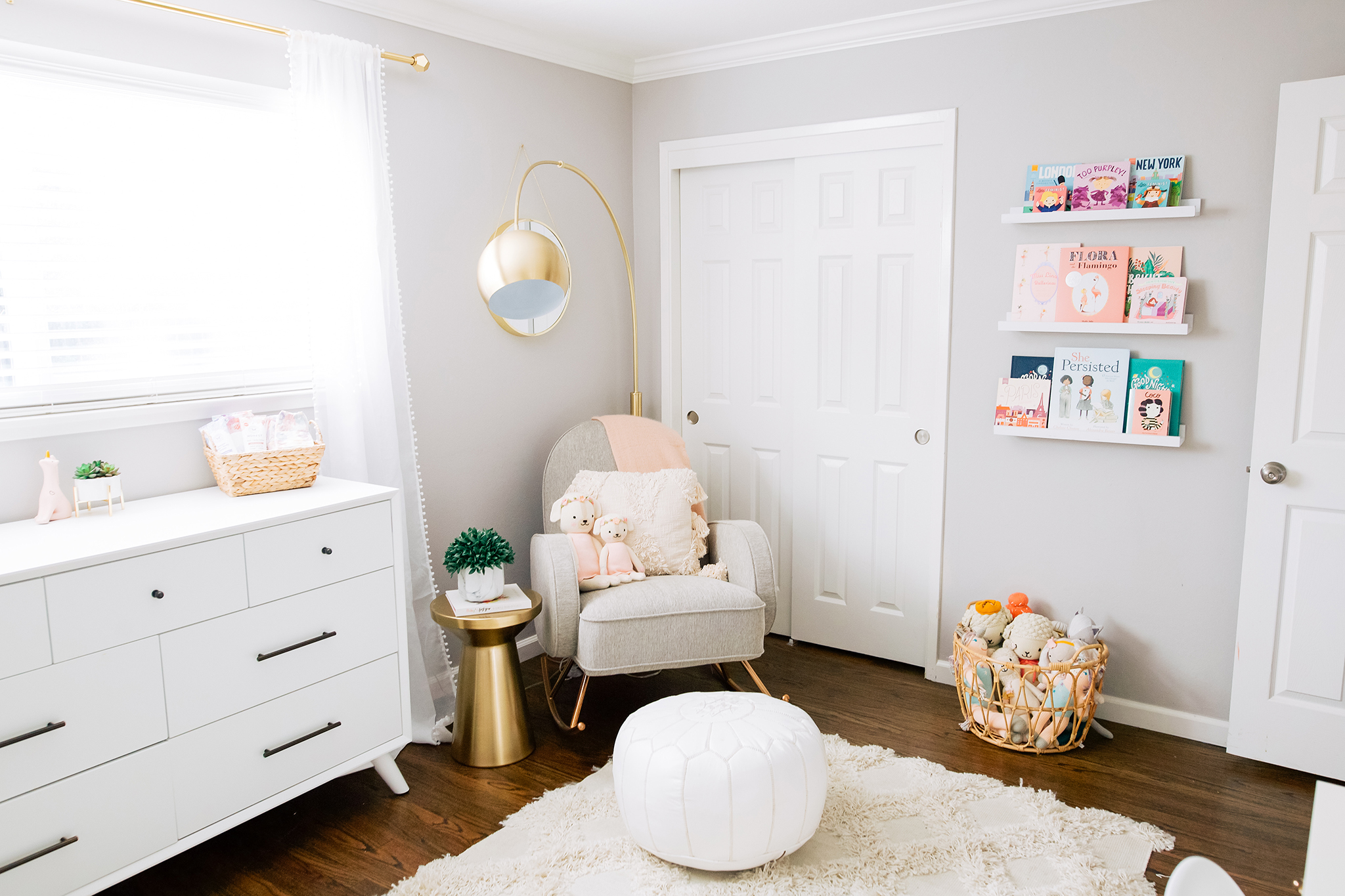 Rocker in Girls Nursery with Gold Arc Floor Lamp