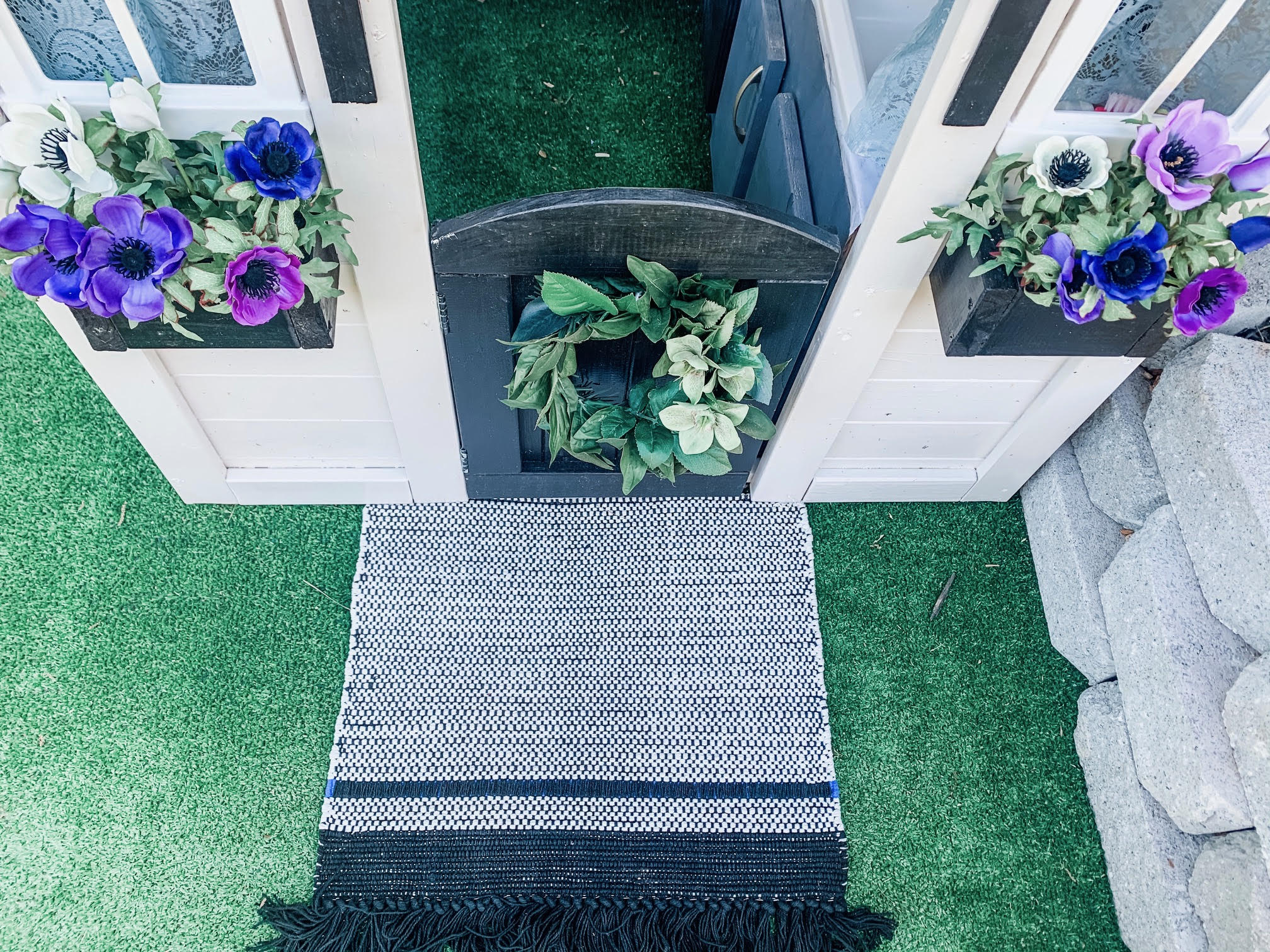 Entrance with flower boxes and rug