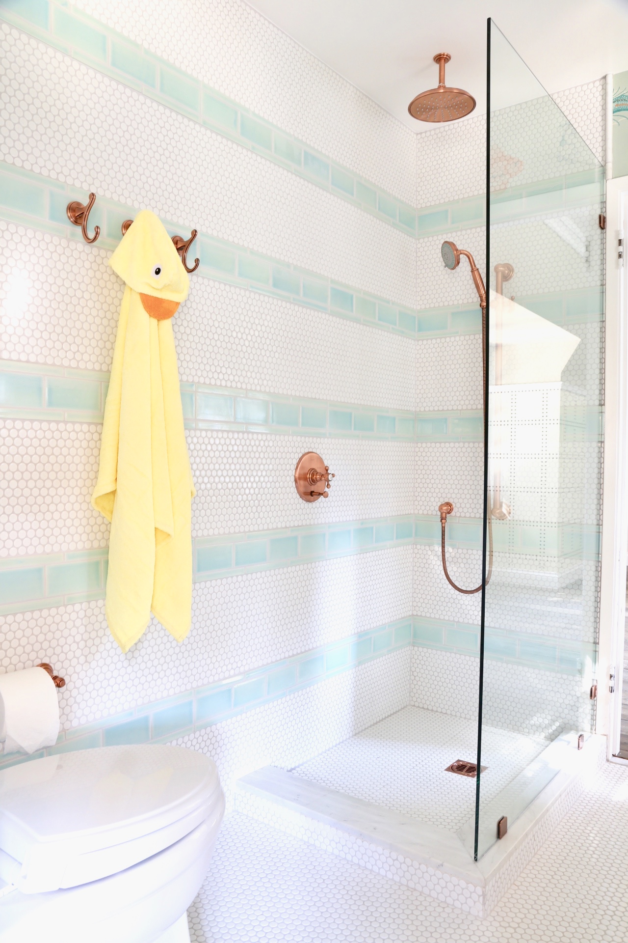 Striped Tile in Kids Bathroom with Copper Bath Fixtures