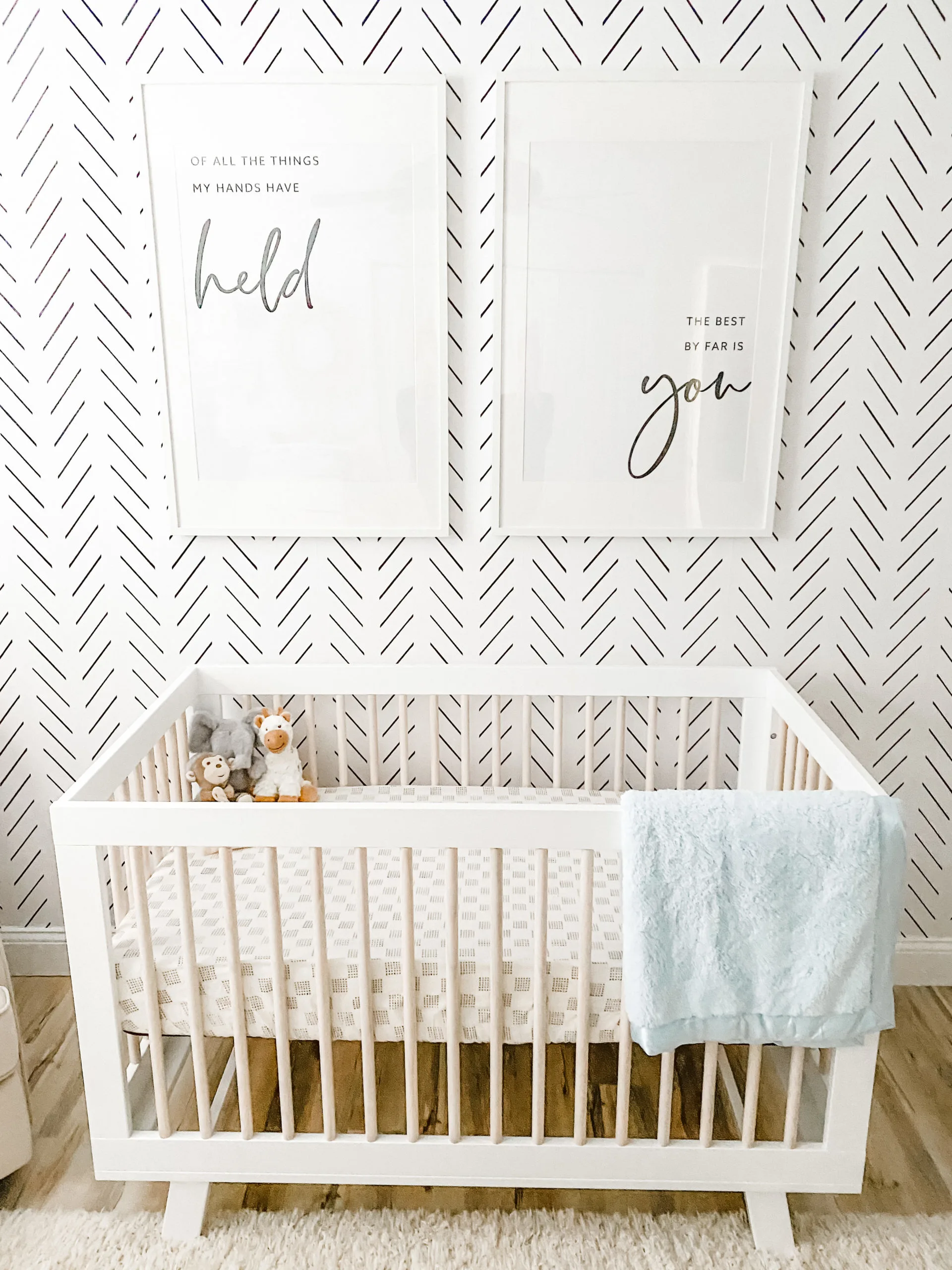 Text Prints Above Crib in Black and White Nursery - Of all the things my hands have held the best by far is you