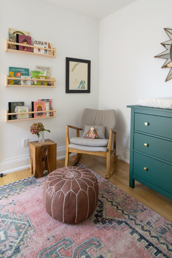 Modern boho nursery with floral wallpaper