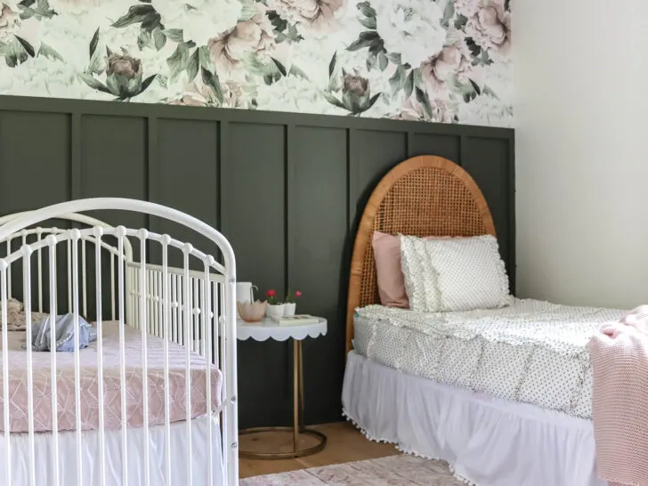 hunter green feature wall of girls room with floral wallpaper